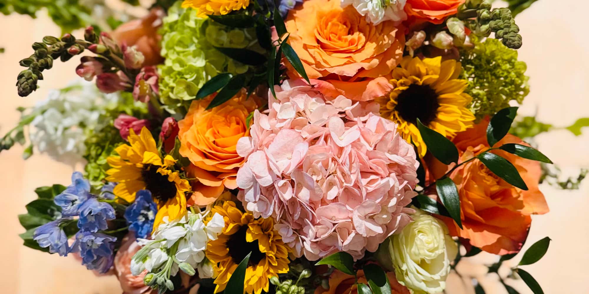 Colorful bouquet of sunflowers, roses and hydrangeas